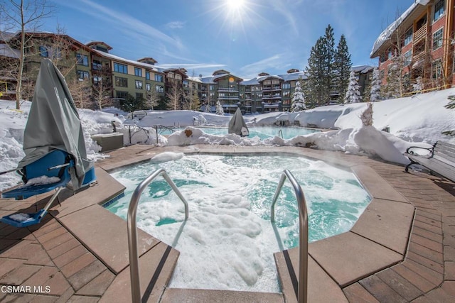 snow covered pool with a community hot tub