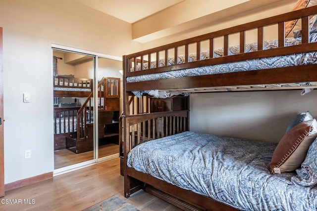 bedroom with wood-type flooring and a closet