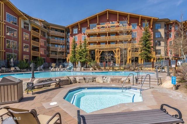 view of swimming pool featuring a community hot tub