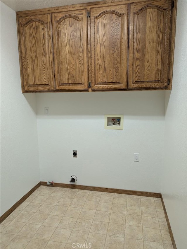 laundry room featuring washer hookup, hookup for an electric dryer, gas dryer hookup, and cabinets