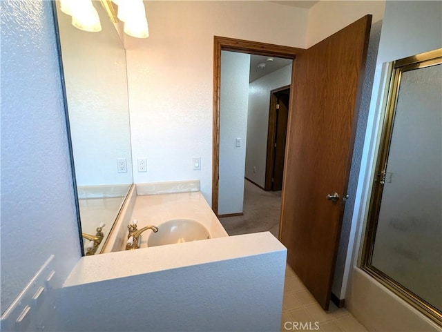 bathroom with tile patterned floors, shower / bath combination with glass door, and vanity