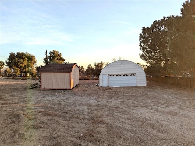 view of garage at dusk