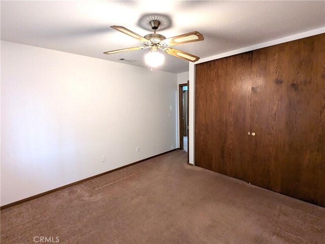 spare room with ceiling fan and carpet flooring