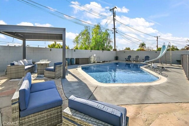 view of swimming pool with a water slide, an outdoor hangout area, and a patio