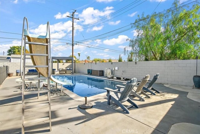 view of pool with a patio area and a water slide