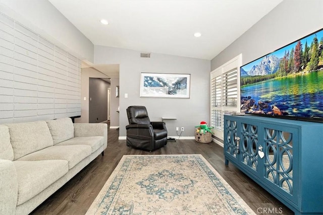 living room with lofted ceiling and dark hardwood / wood-style floors