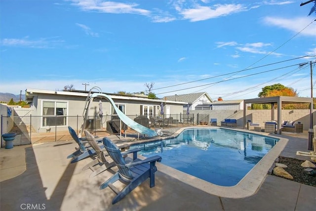 view of pool featuring a patio and a water slide