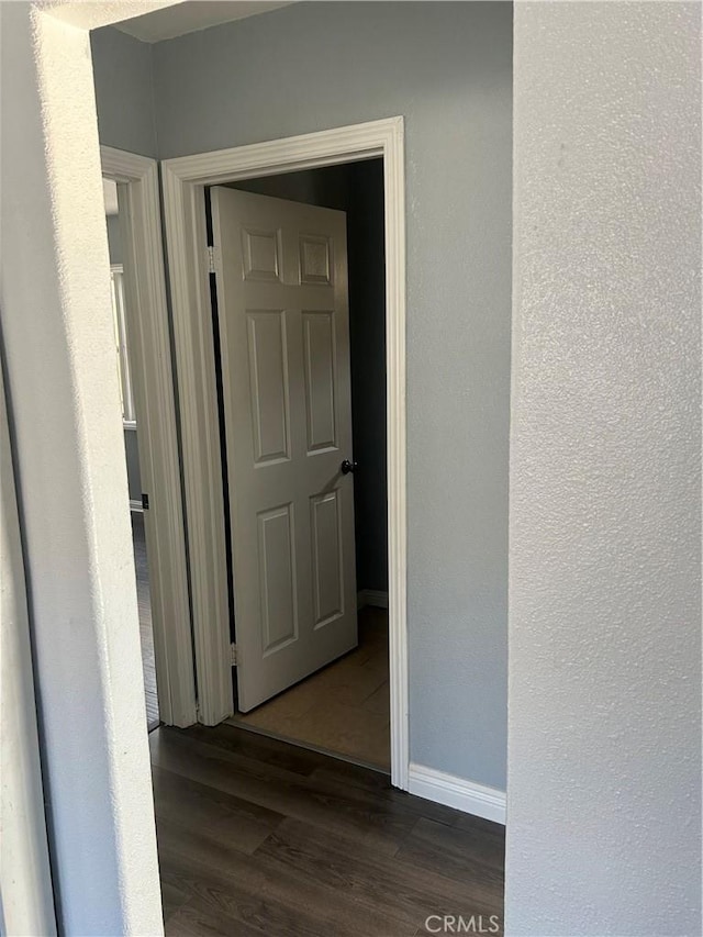 corridor featuring dark hardwood / wood-style flooring