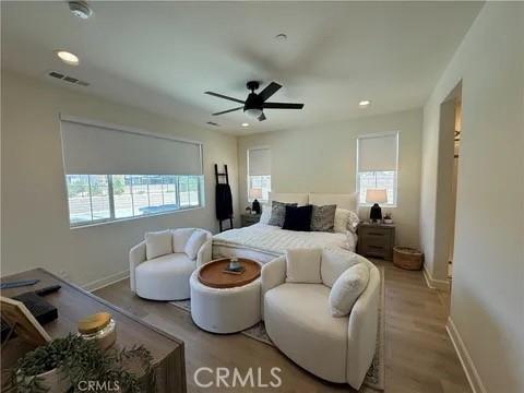 bedroom featuring light wood-type flooring and ceiling fan