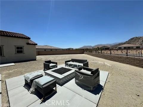 view of patio / terrace with a mountain view and an outdoor fire pit