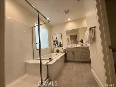 bathroom featuring separate shower and tub, vanity, and tile patterned flooring