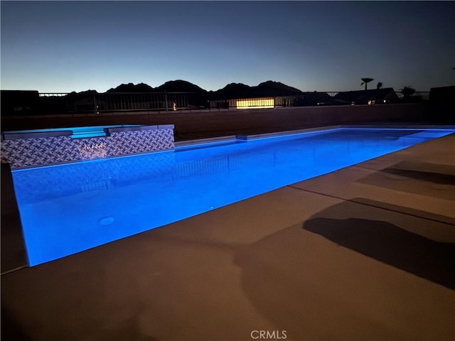 view of pool at dusk