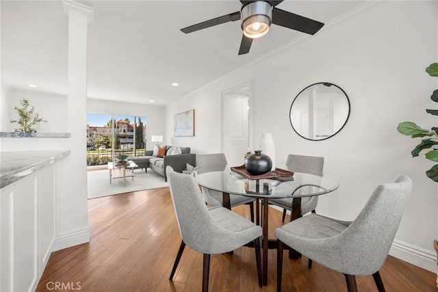 dining space featuring crown molding, ceiling fan, and light hardwood / wood-style flooring