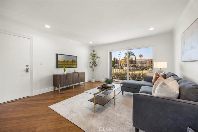 living room with crown molding and light hardwood / wood-style flooring