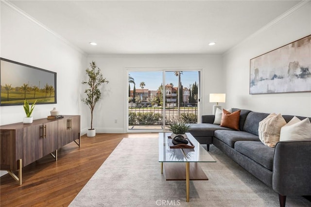 living room with hardwood / wood-style flooring and ornamental molding