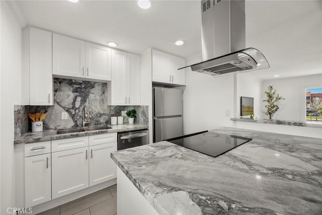 kitchen with white cabinetry, island exhaust hood, and appliances with stainless steel finishes