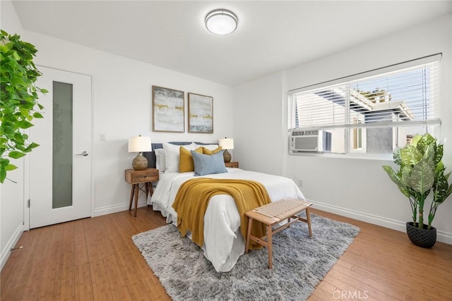 bedroom featuring cooling unit and hardwood / wood-style floors