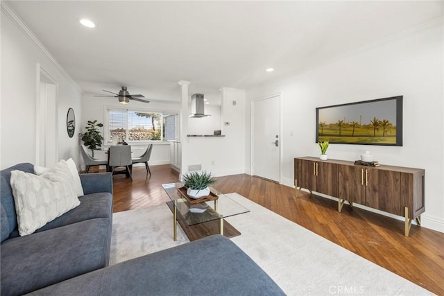 living room featuring hardwood / wood-style flooring and crown molding