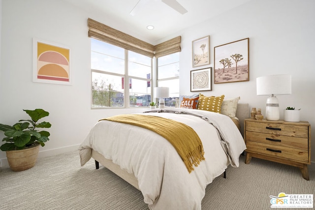 bedroom with ceiling fan and light colored carpet