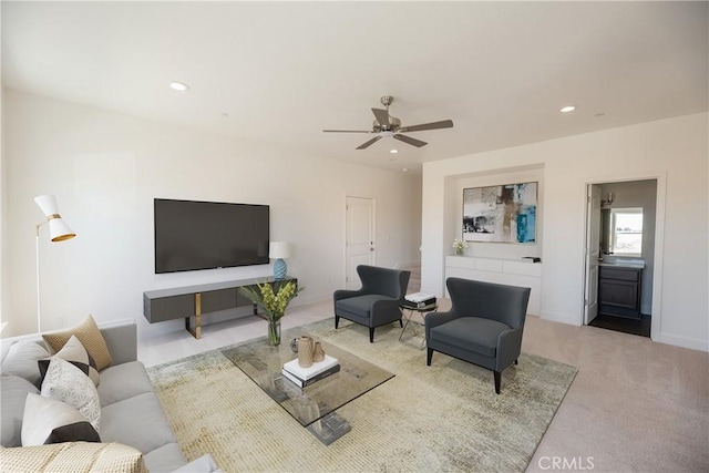 carpeted living room featuring ceiling fan