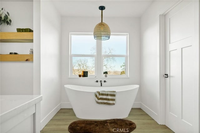 bathroom featuring hardwood / wood-style flooring and a washtub