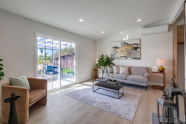 living room featuring light wood-type flooring and an AC wall unit