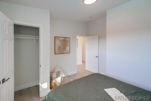 unfurnished bedroom with wood-type flooring and a closet