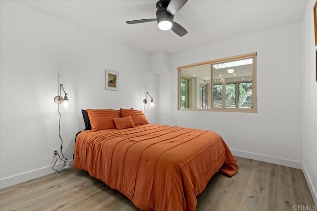 bedroom with light wood-type flooring and ceiling fan