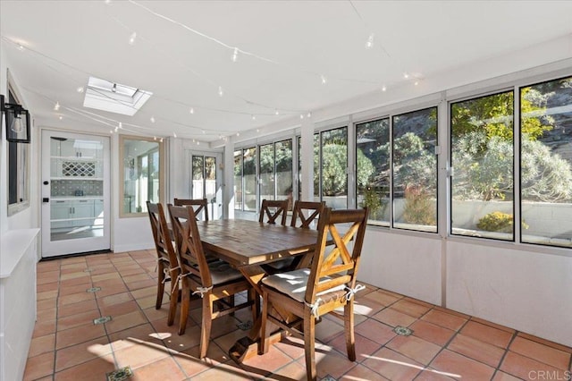 sunroom / solarium with a healthy amount of sunlight and a skylight