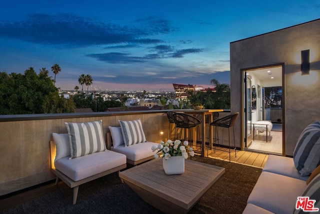 exterior space featuring a balcony and outdoor lounge area