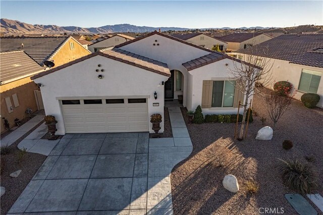 view of front of house with a mountain view and a garage