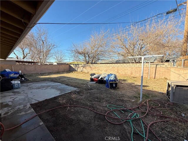 view of yard with a patio and central AC