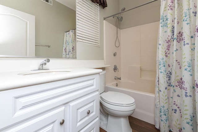 full bathroom featuring shower / bathtub combination with curtain, vanity, toilet, and hardwood / wood-style flooring