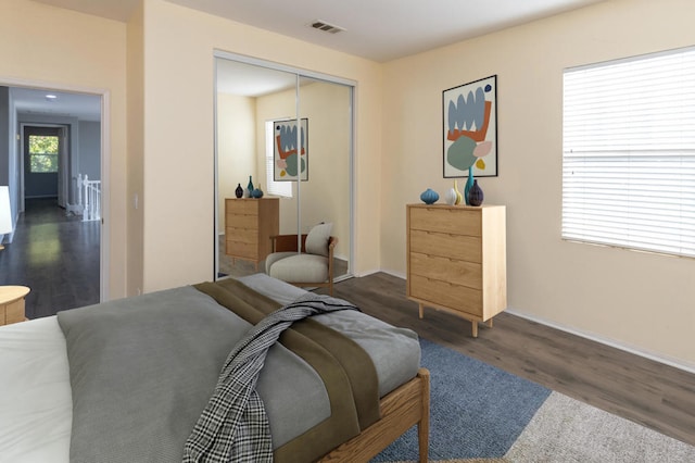 bedroom with a closet and dark hardwood / wood-style flooring