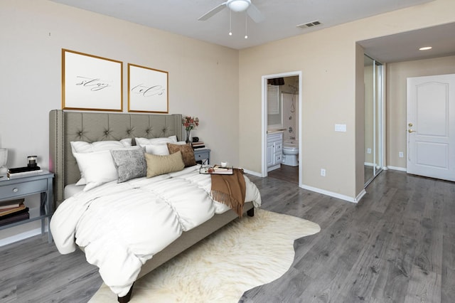 bedroom with ceiling fan, connected bathroom, and hardwood / wood-style floors