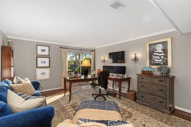 home office with visible vents, crown molding, and baseboards