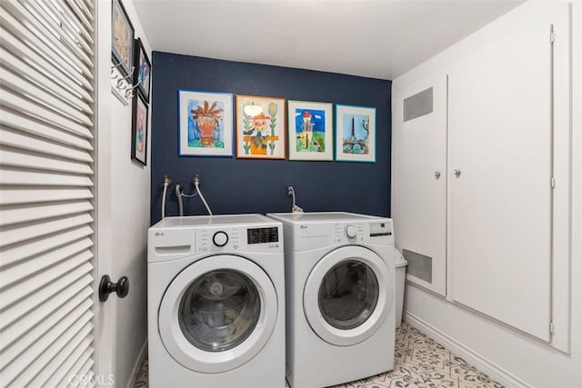 clothes washing area with laundry area, visible vents, and separate washer and dryer