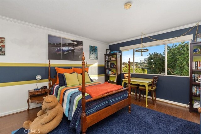 bedroom with crown molding and dark hardwood / wood-style floors