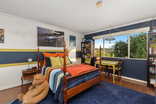 bedroom with dark wood-style flooring, crown molding, and baseboards