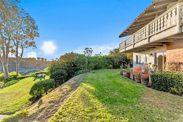 view of yard featuring a mountain view and a balcony