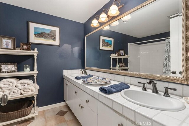 bathroom featuring tile patterned floors, vanity, and a shower with curtain