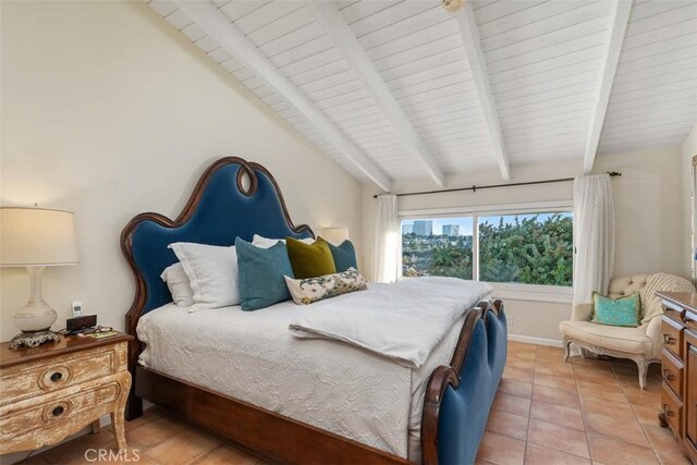 bedroom featuring beam ceiling and light tile patterned flooring