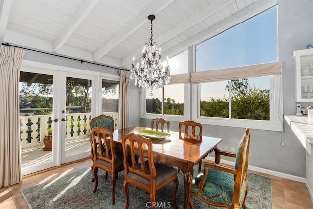 sunroom / solarium with lofted ceiling with beams, a chandelier, and french doors