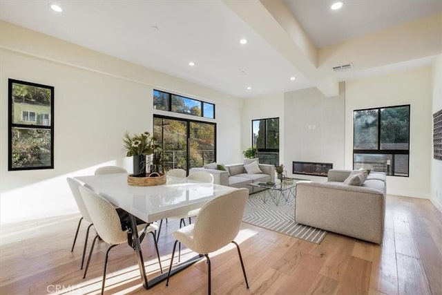 interior space featuring beamed ceiling and light hardwood / wood-style floors