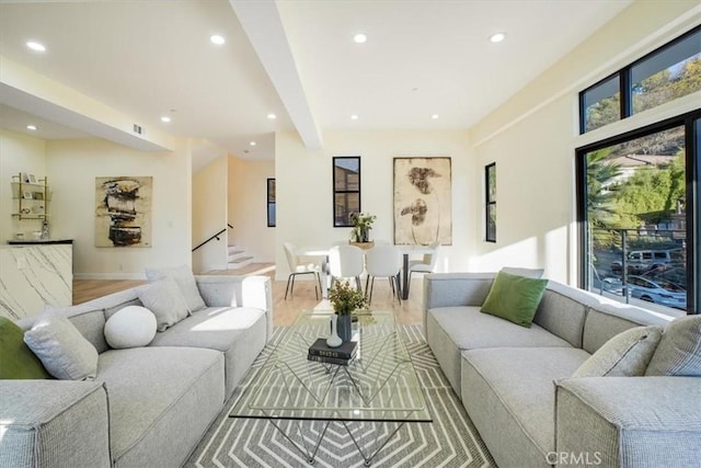 living room with wood-type flooring and beamed ceiling