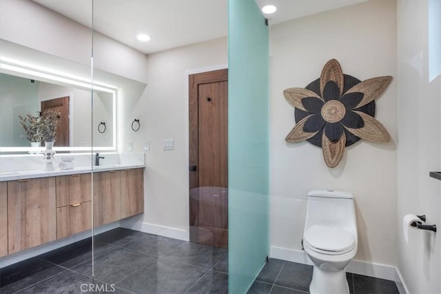 bathroom with toilet, tile patterned floors, and vanity