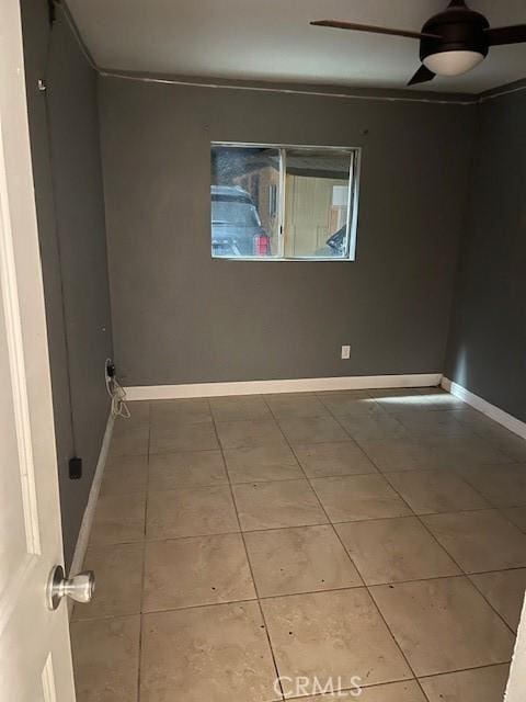 unfurnished room featuring ceiling fan and tile patterned floors