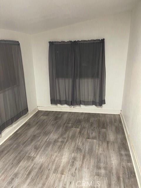 unfurnished room featuring dark hardwood / wood-style floors