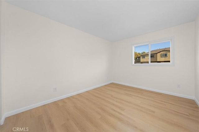 empty room with light hardwood / wood-style floors