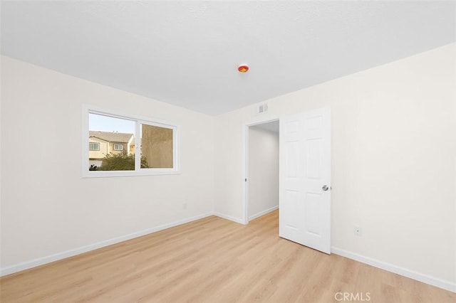 spare room with light hardwood / wood-style floors